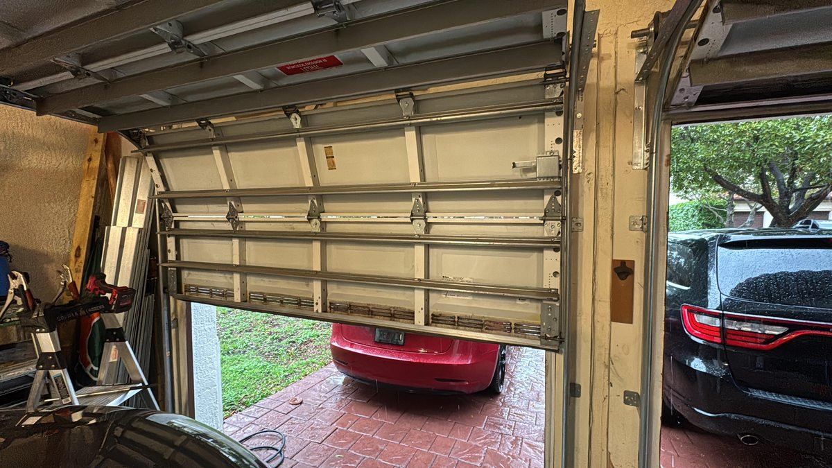 911 Garage Door technician on the job